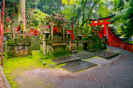 KYOTO, JAPAN - JULY 05, 2017: Mitsurugi Shrine Choja Shrine prayer area at Fushimi Inari Taisha Shrine, with a guge red door, it is a famous historic site in Kyoto, Japanのeditorial素材