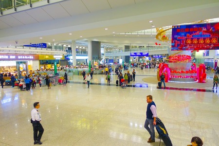 HONG KONG, CHINA - JANUARY 26, 2017: Passengers in the airport main lobby in Hong Kong, China. The Hong Kong airport handles more than 70 million passengers per yearのeditorial素材