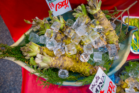 OSAKA, JAPAN - JULY 18, 2017: Fresh wasabi root are sold along the street at Kuromon Ichiba market, Nipponbashi, Osaka, Japanのeditorial素材