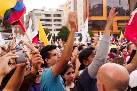 Quito, Ecuador - April 7, 2016: Crowd of unidentified people with ecuadorian and white flags supporting the presidential candidate Guillermo Lasso, and journalists during anti government protests in Shyris Avenueのeditorial素材