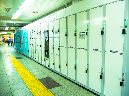 Tokyo, Japan - Jan 2, 2016. Close up of a locker and unidentified people walking near of Yamanote train in Tokyo, Japan. The railway system in Japan has a high reputation for punctuality and safetyのeditorial素材