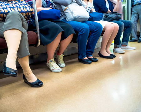 Tokyo, Japan - Jan 2, 2016: Close up of legs pf people in a Yamanote train in Tokyo, Japan. The railway system in Japan has a high reputation for punctuality and safetyのeditorial素材