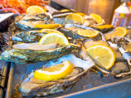 TOKYO, JAPAN JUNE 28 - 2017: Clam with a piece of lemon for sale at the Fish Market Tsukiji wholesale in Tokyo Japan, Tsukiji Market is the biggest wholesale fish and seafood market in the worldのeditorial素材