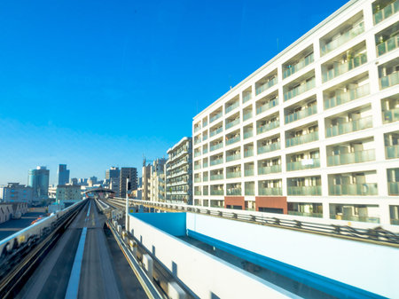 TOKYO, JAPAN JUNE 28 - 2017: Scenery of a train traveling on the elevated rail of Yurikamome Line in...