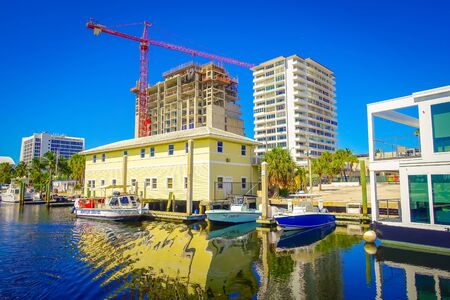 FORT LAUDERDALE, USA - JULY 11, 2017: Many yatchs parked in a pier with a beautiful new construction behing in the city of Fort Lauderdale, Floridaのeditorial素材