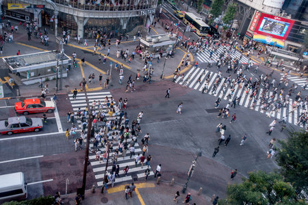 TOKYO, JAPAN JUNE 28 - 2017: Top view of crowd of people crossing in Shibuya street, one of the busiest crosswalks in the world, in the Ginza District in Tokyoのeditorial素材