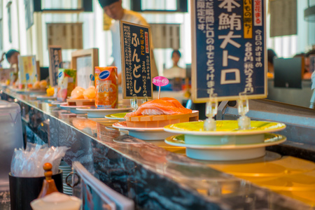 TOKYO, JAPAN -28 JUN 2017: Close up of assorted japanesse food over a table, inside of a kaitenzushi conveyor belt sushi restaurant in Tokyoのeditorial素材