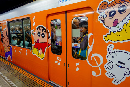 TOKYO, JAPAN - CIRCA MAY 2014: Crowd of passengers inside of train at Ikebukuro station in Tokyo, Japan. Ikebukuru is the second-busiest railway station in the worldのeditorial素材