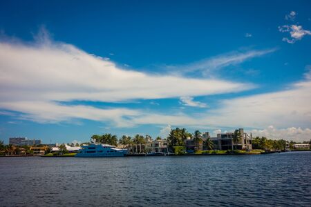 FORT LAUDERDALE, USA - JULY 11, 2017: Beautiful view of new river with riverwalk promenade highrise condominium buildings and yachts parked in the river, in Fort Lauderdale, Florida.のeditorial素材