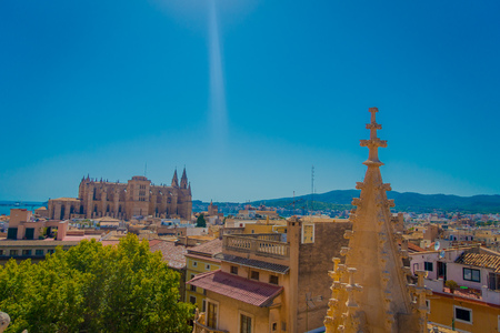 PALMA DE MALLORCA, SPAIN - AUGUST 18 2017: Gorgeous view of rooftops of the city of Palma de Mallorca with the Cathedral of Santa Maria in the horizont in a beautiful blue sunny day in Palma de Mallorca, Spainのeditorial素材