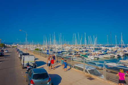 PALMA DE MALLORCA, SPAIN - AUGUST 18 2017: Unidentified people walking at harbor with white yachts in the water, in Palma de Mallorca, Balearic islands, Spainのeditorial素材