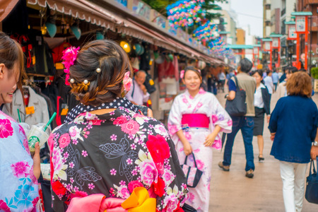 TOKYO, JAPAN JUNE 28 - 2017: Unidentified woman taking a picture of her friend in the Buddhist Temple Sensoji in Tokyo, Japan. The Sensoji temple in Asakusa area is the oldest temple in Tokyoのeditorial素材