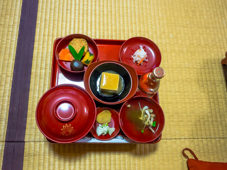 Close up of a lunch served in a red plates, in a restaurant in Japanの写真素材