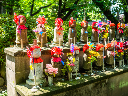 TOKYO, JAPAN - APRIL 5: Jizo Boddhisattvas at Zojo Buddhist Temple at Tokyo, Japan. Jizo Bodhisattva is the patron saint of thechildrens soul according to the Japanese mythologyのeditorial素材