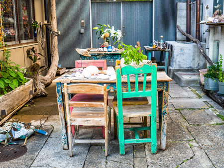 TOKYO, JAPAN JUNE 28 - 2017: Outdoor view of old table and chairs in a restaurant at Komachi-dori Street, in Kamakura in Tokyo Japanのeditorial素材