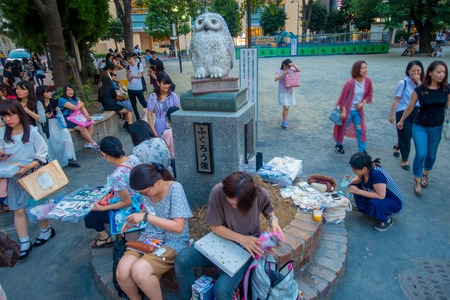 TOKYO, JAPAN JUNE 28 - 2017: Unidentified people waiting near of an owl statue at Ikebukuro district of Tokyo metropolis, Japanのeditorial素材