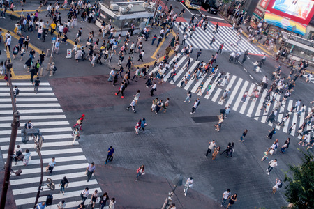 TOKYO, JAPAN JUNE 28 - 2017: Top view of crowd of people crossing in Shibuya street, one of the busiest crosswalks in the world, in the Ginza District in Tokyoのeditorial素材