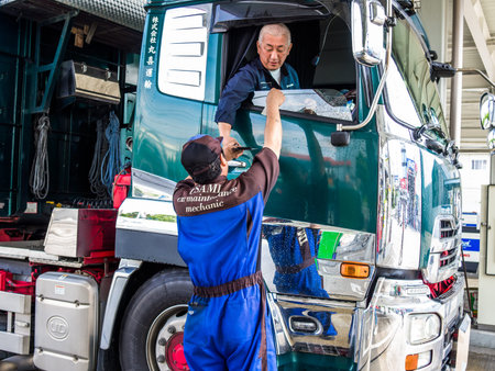 YUFUIN, JAPAN JUNE 28 - 2017: Close up of a driver paying the gasoline at gas station Yufuin village in Japanese styleのeditorial素材