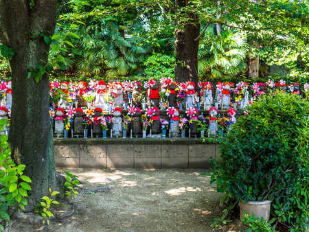 TOKYO, JAPAN - AUGUST 5 2017: Jizo Boddhisattvas at Zojo Buddhist Temple at Tokyo, Japan. Jizo Bodhisattva is the patron saint of thechildrens soul according to the Japanese mythologyのeditorial素材