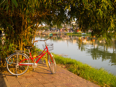 Hoian, Vietnam - August 20, 2017: Close up of a red bike parked in the park, in Hoi An ancient town, in Vietnamのeditorial素材