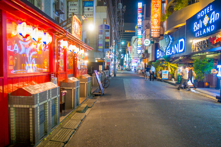 TOKYO, JAPAN JUNE 28 - 2017: Unidentified people walking at beautiful famous Kabukicho red lights district, surrounding of big buildings and advertisements, located in the city of Tokyoのeditorial素材
