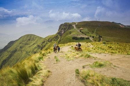 Pichincha, Ecuador September 18, 2017: Tourist riding a horse on the top of the Pichincha mountain with a panoramic view at the Pichincha volcano, located just to the side of Quito, which wraps around its eastern slopesのeditorial素材