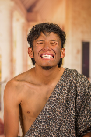 Close up of funny prehistoric man smiling to the camera in a blurred backgroundの写真素材