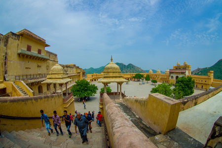 Amer, India - September 19, 2017: Unidentified people walking in the plaza and enjoying the gorgeous view of the old structure inside of the palace in Amber Fort, located in Amer, Rajasthan, India, fish eye effectのeditorial素材