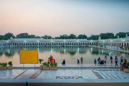 DELHI, INDIA - SEPTEMBER 19, 2017: Unidentified people swimming and washing their heads as lucky in the pond in the Famous Sikh gurdwara Golden Temple Harmandir Sahib in Indiaのeditorial素材