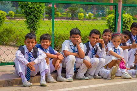 Delhi, India - September 16, 2017: Unidentified group of children wearing sport clothes, sitting at outdoors in the streets in Delhi, Indiaのeditorial素材