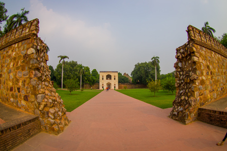 DELHI, INDIA - SEPTEMBER 19, 2017: Stoned wall with a pavement path in the garden in the Isa Khan Tomb at Humayuns Tomb complex in Delhi, India. Humayuns Tomb was the first garden-tomb on the Indian subcontinent, fish eye effectのeditorial素材