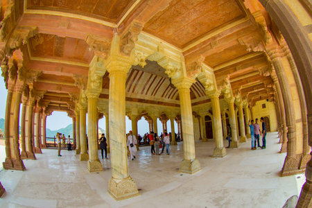 Amer, India - September 19, 2017: Unidentified people walking inside of the collumned hall in Sattais Katcheri in Amber Fort near Jaipur, Rajasthan, India. Amber Fort is the main tourist attraction in the Jaipur area, fish eye effectのeditorial素材