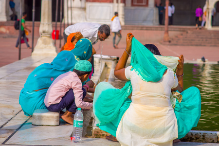 Delhi, India - September 27, 2017: Unidentified people clean thenself their faces in the courtyard of Jama Masjid Mosque in Delhi, Indiaのeditorial素材