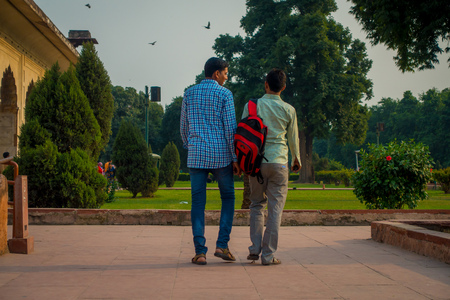 DELHI, INDIA - SEPTEMBER 25 2017: Unidentified gay couple holding their hands and walking around Inlaid marble, columns and arches, Hall of Private Audience or Diwan I Khas at the Lal Qila or Red Fort in Delhi, India, fish eye effectのeditorial素材