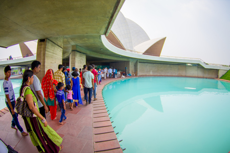 Delhi, India - September 27, 2017: Unidentified people inside of the huge stoned structure Lotus Temple, near of an artificial pool of turquoise water, located in New Delhi, India, is a Bahai House of Worship, fish eye effectのeditorial素材