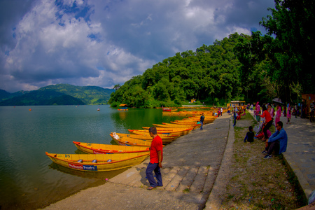 POKHARA, NEPAL - NOVEMBER 04, 2017: Unidentified people enjoying the view of the lake with wooden boat at Begnas lake in Pokhara, Nepalのeditorial素材