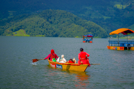 POKHARA, NEPAL - NOVEMBER 04, 2017:Gorgeous family enjoying of a beautiful day over a yellow boat at Begnas lake in Pokhara, Nepal.のeditorial素材
