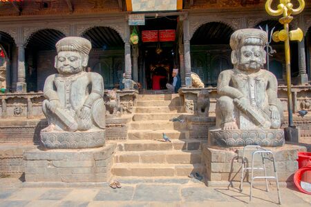 BHAKTAPUR, NEPAL - NOVEMBER 04, 2017: Street food market with some motorcycles parked in old and sandy street in a rustic town located in Bhaktapur, Nepalのeditorial素材