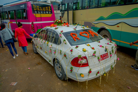POKHARA, NEPAL OCTOBER 10, 2017: Beautiful car adorned with flowers and villagers celebrating a nepalese wedding in Besisahar, Nepa.のeditorial素材