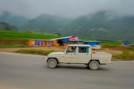 POKHARA, NEPAL OCTOBER 10, 2017: Unidentified man driving his car on the road in the streets located...