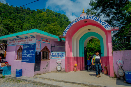 Pokhara, Nepal - September 12, 2017: Unidentified man at the entrance of Bat Cave, in Nepali language, it is called Chameri Gufa. The cave is made of limestone and habitats of the bats over the cave's wall and the ceilings.のeditorial素材