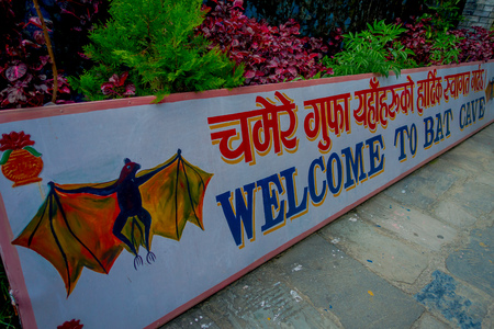 Pokhara, Nepal - September 12, 2017: Informative sign at the entrance of Bat Cave, in Nepali language, it is called Chameri Gufa. The cave is made of limestone and habitats of the bats over the cave's wall and the ceilings.のeditorial素材