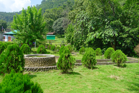 POKHARA, NEPAL OCTOBER 10, 2017: Beautiful garden in the enter of bat cave with a stoned structure in the middle of the jarden in Pokhara, Nepalのeditorial素材