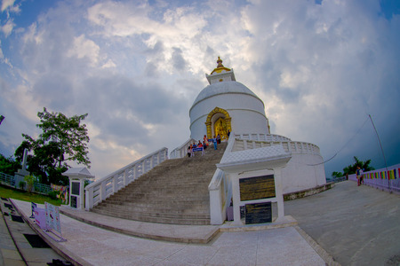 POKHARA, NEPAL, SEPTEMBER 04, 2017: Balanced on a narrow ridge high above Phewa Tal, the brilliant-white World Peace Pagoda in Pokhara is a massive Buddhist stupa, fish eye effectのeditorial素材
