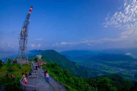 POKHARA, NEPAL, SEPTEMBER 04, 2017: Unidentified tourist sitting in the ground at hilltop of the Sarangkot lookout point in the mountain to view Annapurna Range during sunrise at Sarangkot, Nepal, fish eye effectのeditorial素材