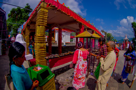 KATHMANDU, NEPAL - SEPTEMBER 04, 2017: Unidentified group of people at outdoors burning incenses near of of Bindabasini temple, is of great religious importance to local Hindus. The temple itself is dedicated to the Hindu goddess Durga, who is Pokharas chのeditorial素材