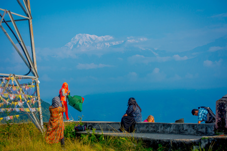 POKHARA, NEPAL, SEPTEMBER 04, 2017: Unidentified tourists at hilltop of the Sarangkot lookout point, holding flags and taking selfies in the mountain to view Annapurna Range during sunrise at Sarangkot, Nepalのeditorial素材