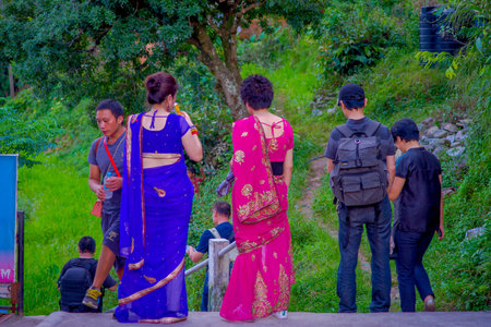 POKHARA, NEPAL, SEPTEMBER 04, 2017: Unidentified people walking inside of the forets