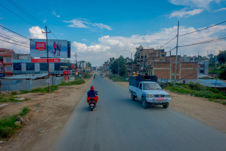 POKHARA, NEPAL OCTOBER 10, 2017: Beautiful view of asphalted road with some motorbikes around in the street, located in Pokhara, Nepalのeditorial素材