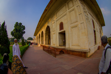 DELHI, INDIA - SEPTEMBER 25 2017: Unidentified old Indian man standing outside of Inlaid marble, columns and arches, Hall of Private Audience or Diwan I Khas at the Lal Qila or Red Fort in Delhi, India, fish eye effectのeditorial素材
